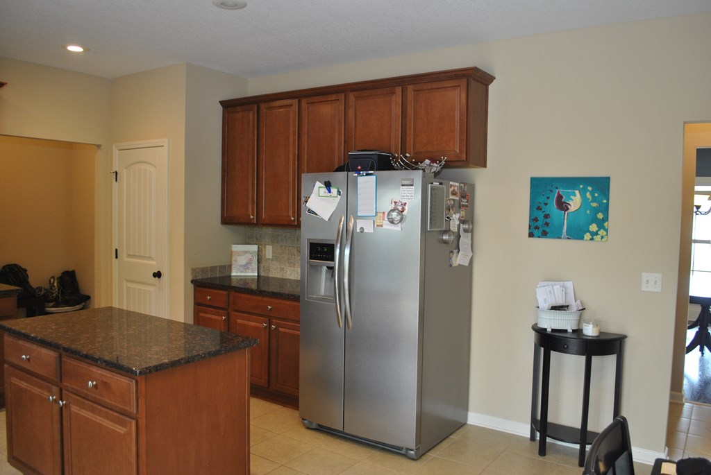 9536 English Ivy Court Fortson, GA 31808 - Photo 6 of 22 a kitchen with stainless steel appliances granite countertop a refrigerator and a stove