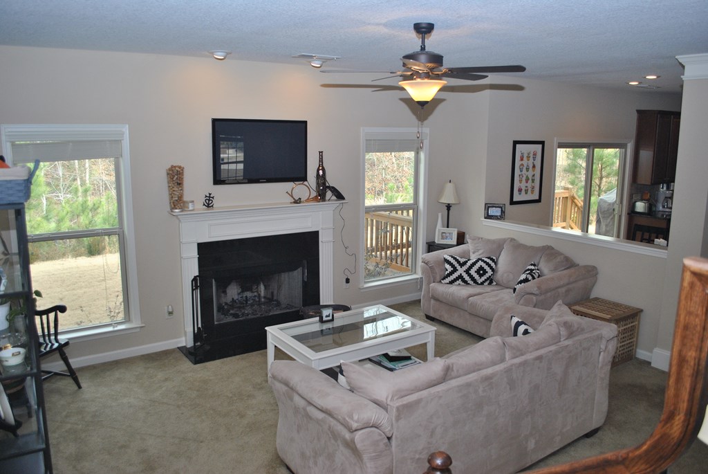 9536 English Ivy Court Fortson, GA 31808 - Photo 9 of 22 a living room with furniture a flat screen tv and a fireplace