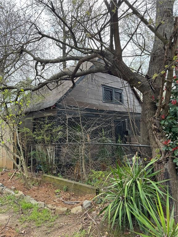 1483 Hardee Street Northeast Atlanta, GA 30317 - Photo 2 of 2 a tall house with trees in front of it