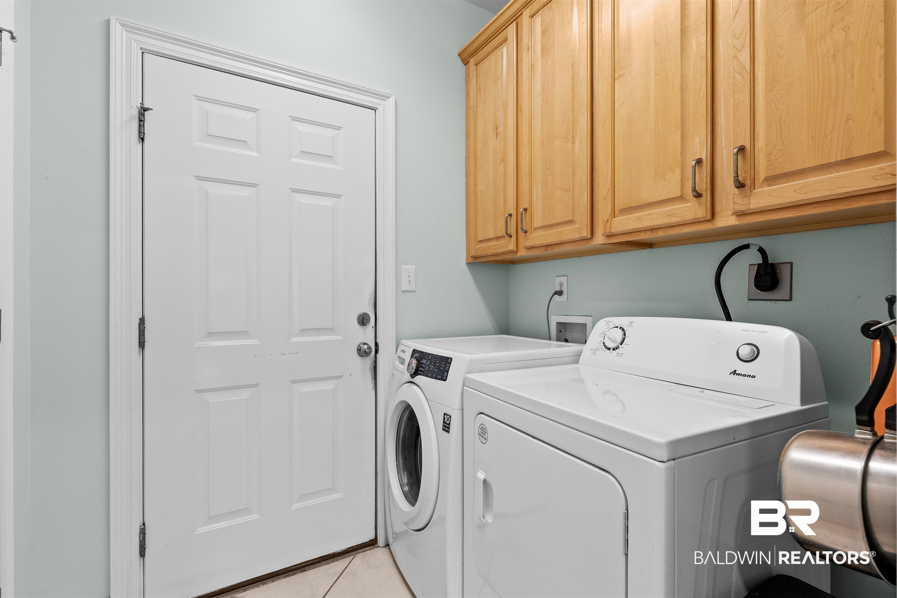 237 Hemingway Loop Foley, AL 36535 - Photo 23 of 49 Laundry room with separate washer and dryer, light tile patterned floors, and cabinet space