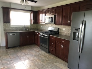 3347 Thornberry Lane Glenview, IL 60025 - Photo 3 of 12 a kitchen with stainless steel appliances granite countertop a refrigerator a sink a stove a microwave a counter space and cabinets