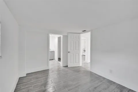 a view of an empty room and wooden floor