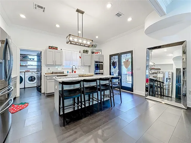 a bathroom with a granite countertop sink mirror vanity and toilet