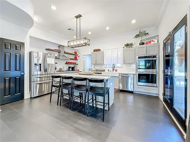 a bedroom with a bed and a flat tv screen on dresser