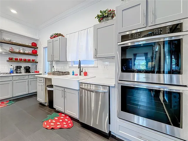 a view of a patio with table and chairs with wooden floor and fence