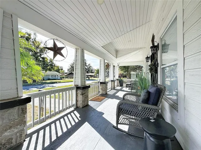a bedroom with furniture and a flat screen tv