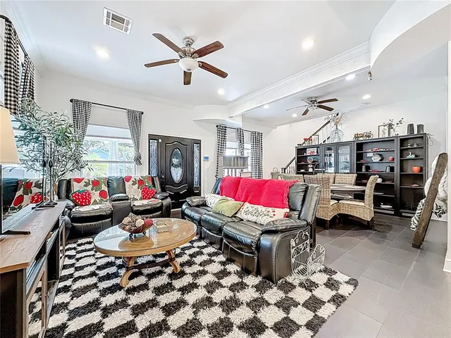 a open kitchen with stainless steel appliances kitchen island granite countertop a stove top oven a sink a dining table and chairs with wooden floor