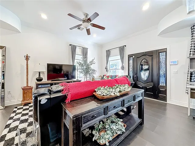 a kitchen with stainless steel appliances kitchen island granite countertop a stove top oven a chimney cabinets and a dining table with the living room view