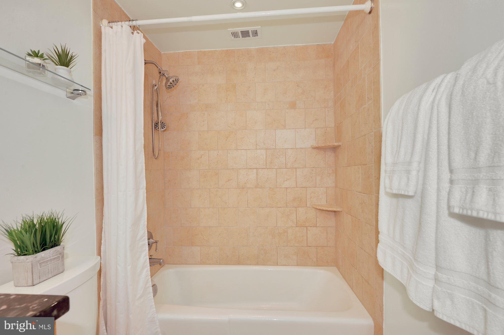 11627 Vantage Hill Road, Unit 1A Reston, VA 20190 - Photo 15 of 27 Shower tile to the ceiling