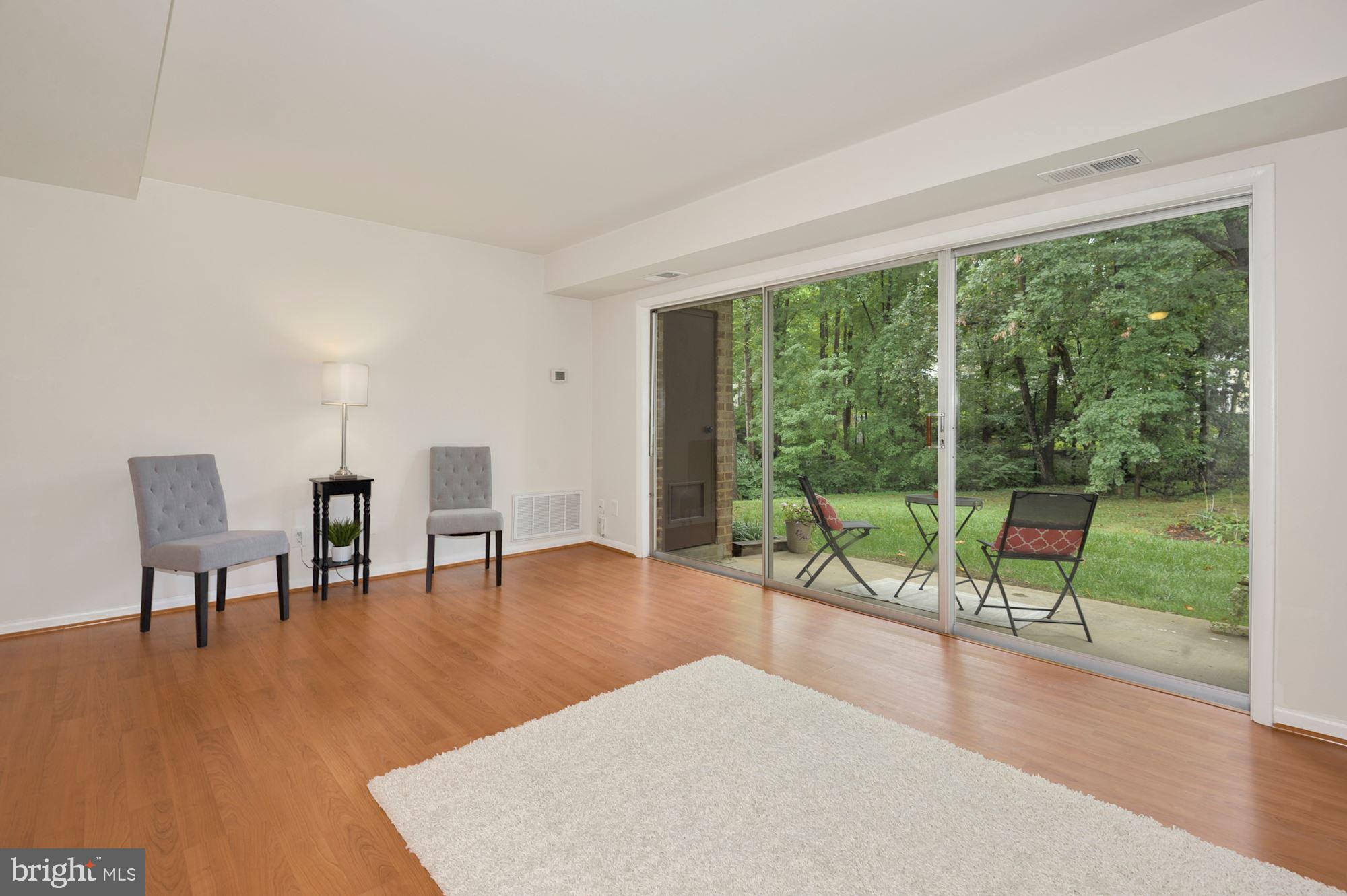 11627 Vantage Hill Road, Unit 1A Reston, VA 20190 - Photo 3 of 27 Sliding glass door to the sheltered patio