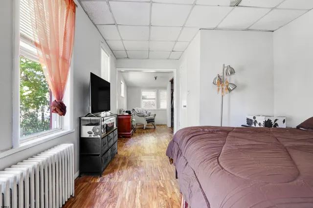 a living room with a bed furniture and a flat tv screen