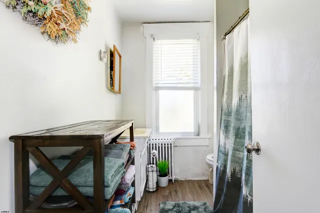 a view of room with window and wooden floor