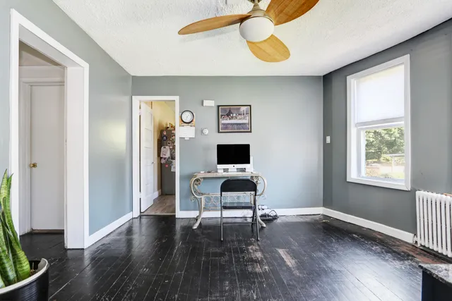 a living room with furniture and a wooden floor