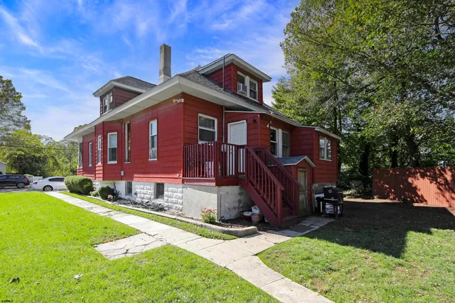 a view of a house with a yard patio and fire pit
