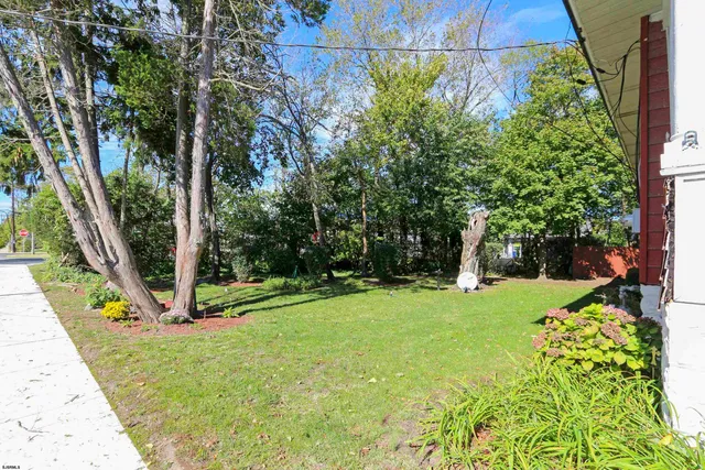a view of a house with a backyard porch and sitting area