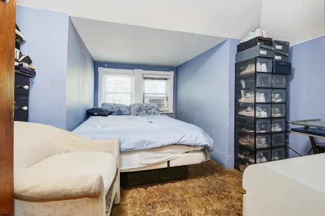 a bedroom with a bed furniture and decor