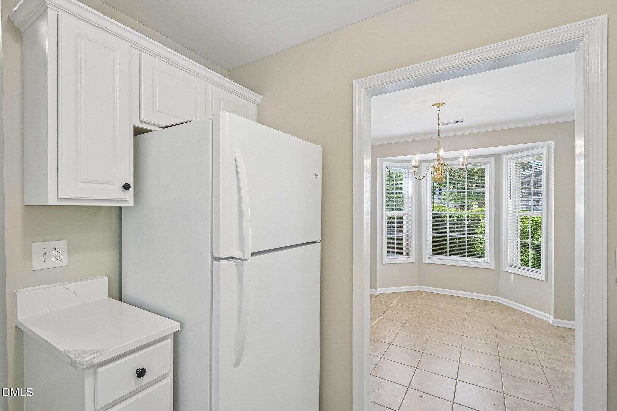 278 South Raleigh Street Angier, NC 27501 - Photo 13 of 35 a white refrigerator freezer and a dishwasher in a kitchen