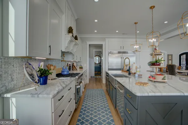 a kitchen with stainless steel appliances a sink stove and cabinets