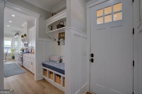a kitchen with stainless steel appliances cabinets and a wooden floor