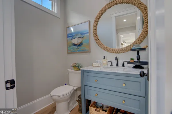 a bathroom with a toilet a sink and mirror
