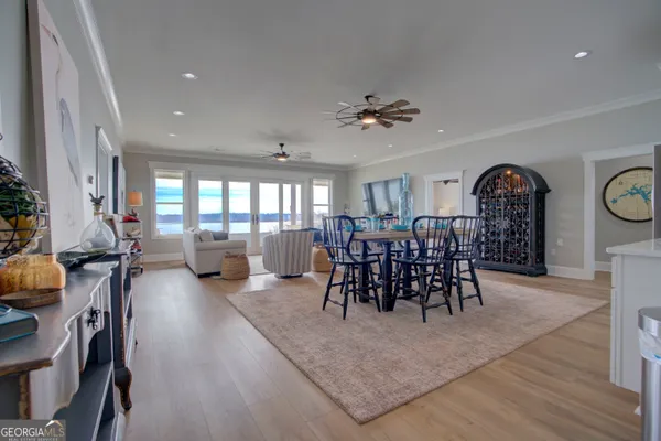 a view of a a dining room with furniture window and wooden floor