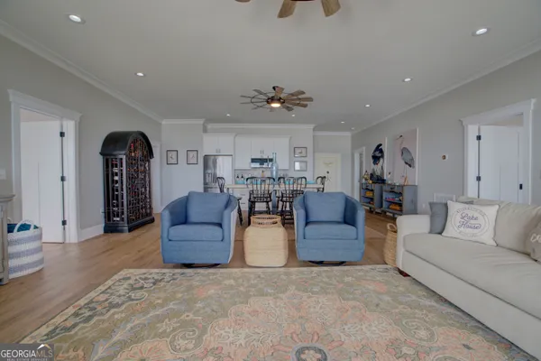 a living room with furniture and wooden floors