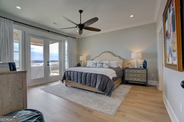 a bedroom with a large bed and a chandelier