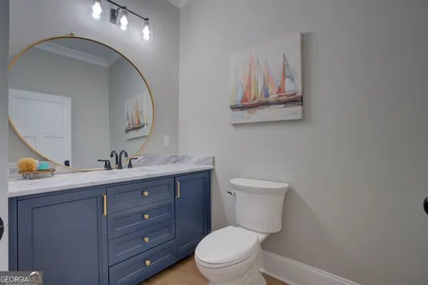 a bathroom with a toilet a sink and mirror