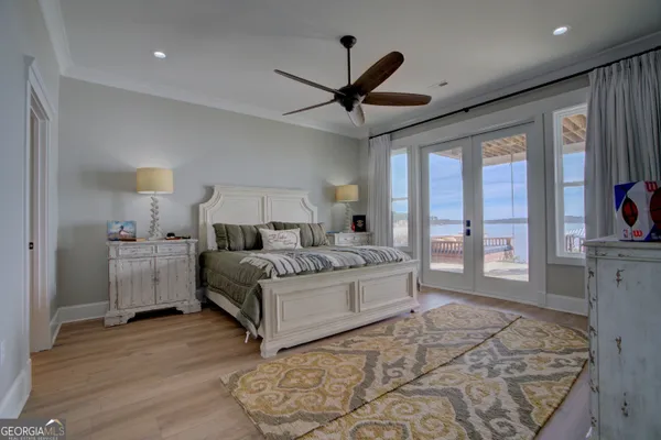 a spacious bedroom with a large bed and a chandelier