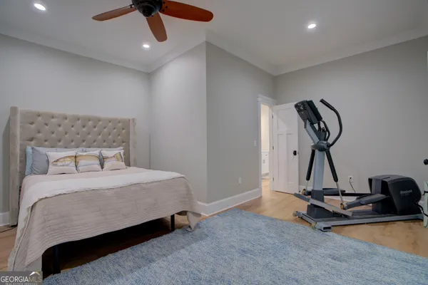 a bedroom with a bed and gym equipment