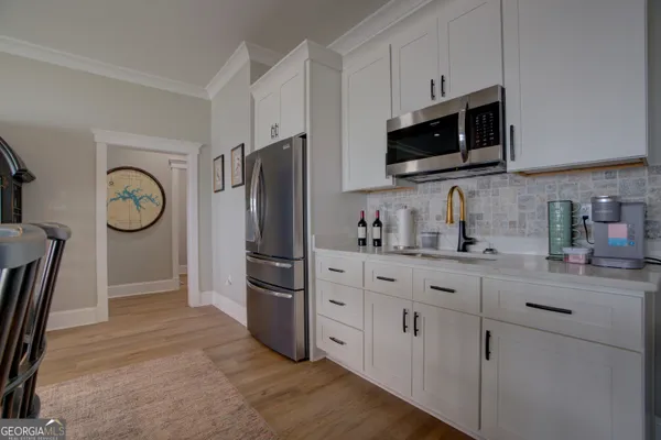 a kitchen with stainless steel appliances a refrigerator stove microwave and sink