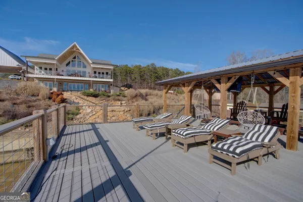 a view of a roof deck with table and chairs