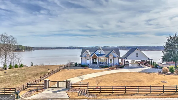 a view of a house with swimming pool and sitting area