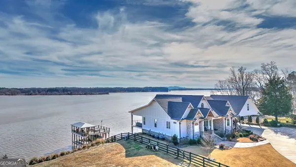 an aerial view of a house with swimming pool and ocean view