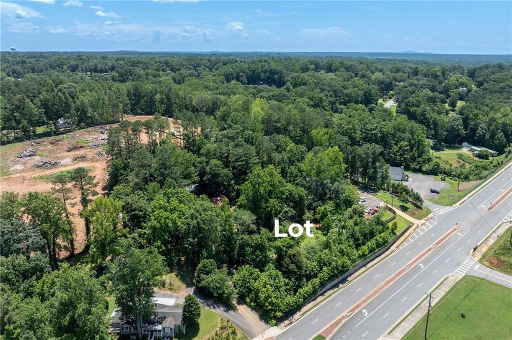 3815 Castleberry Road Cumming, GA 30040 - Photo 3 of 10 a view of a green field with lots of bushes