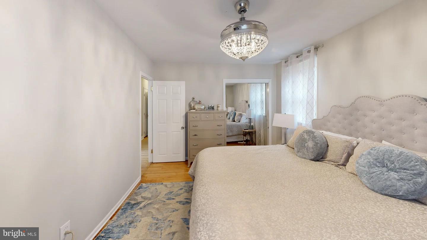 3137 Draper Street Philadelphia, PA 19136 - Photo 22 of 39 a bedroom with a large bed and a chandelier