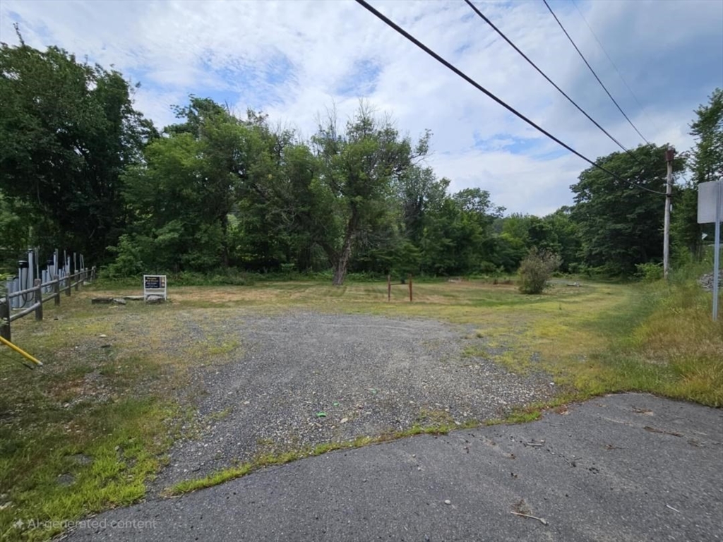10 West Main Street Erving, MA 01344 - Photo 1 of 2 a view of a field with a tree in the background