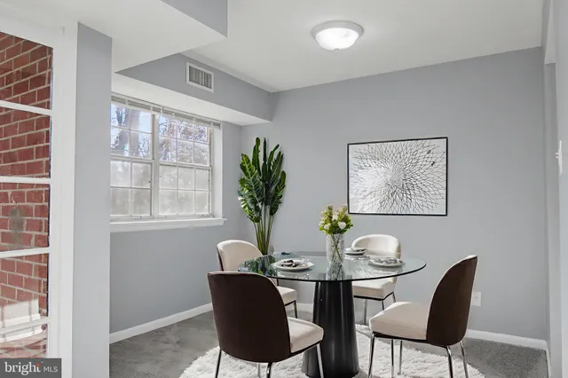 a view of a dining room with furniture window and outside view