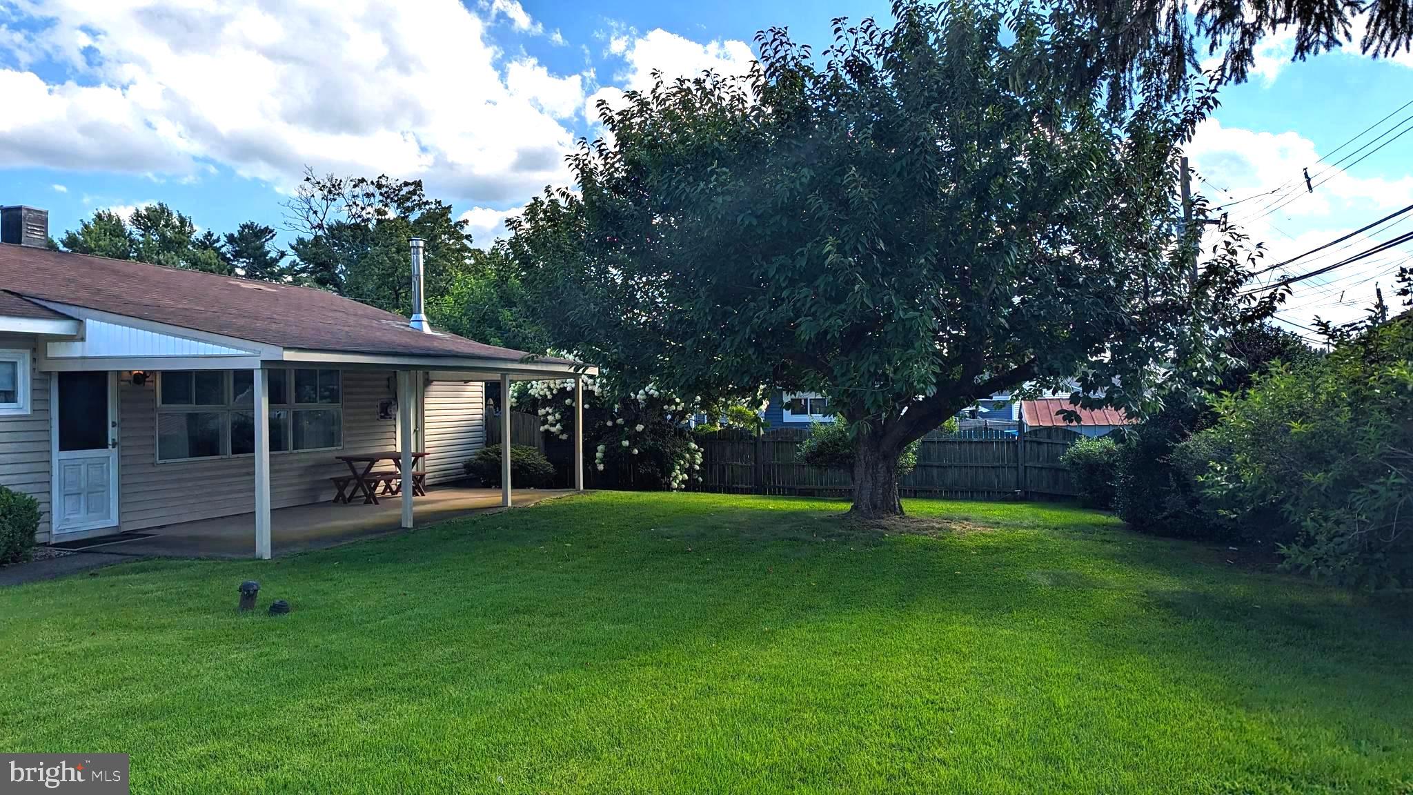 53 Idlewild Road Levittown, PA 19057 - Photo 7 of 15 Maintained lawn and nice size covered patio