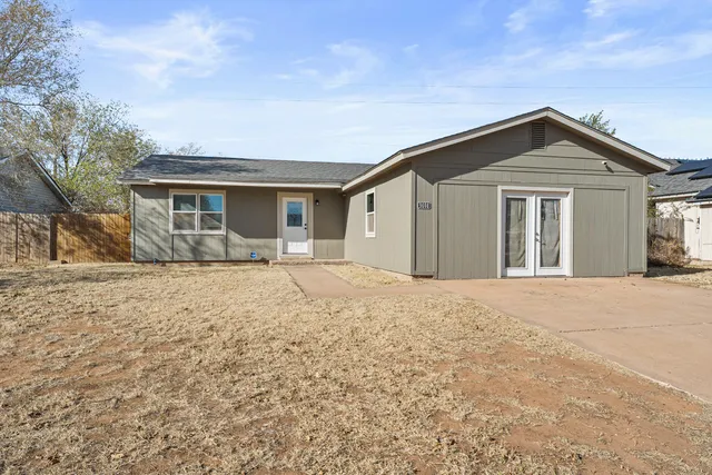 a front view of house with yard and trees