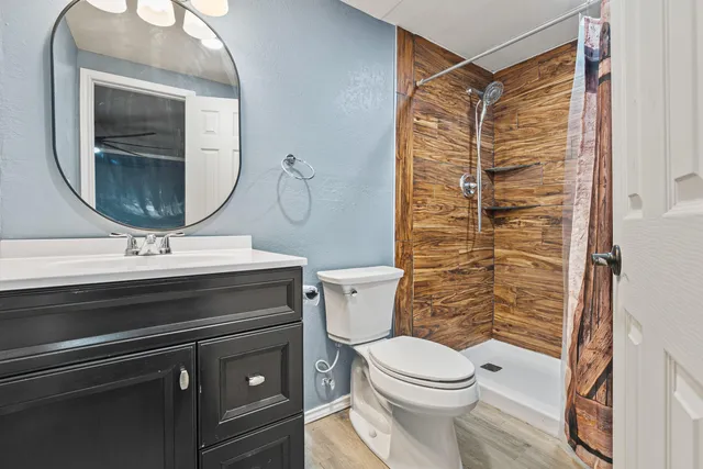 a bathroom with a sink toilet and shower