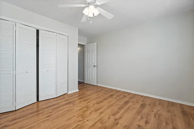 a view of an empty room with wooden floor