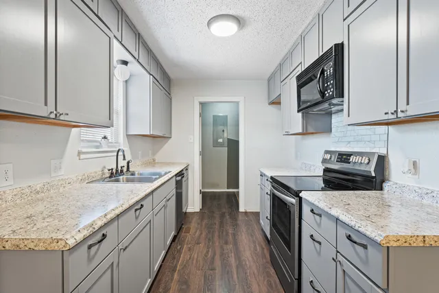a kitchen with a sink stove and cabinets