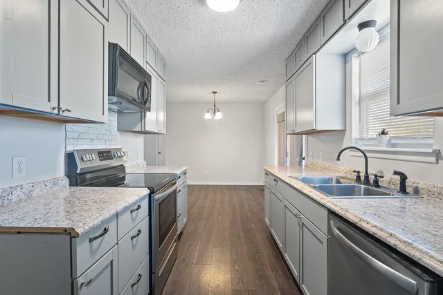 a kitchen with a sink and cabinets