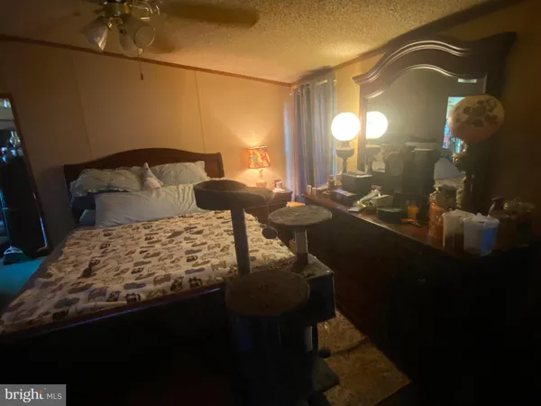 a bedroom with a bed and a mirror