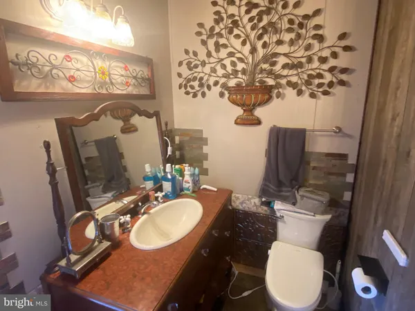 a bathroom with a toilet sink and mirror