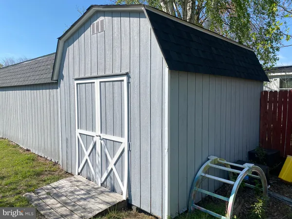 a view of backyard with roof deck and wooden fence