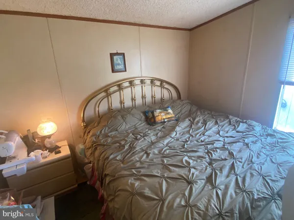 a large bed sitting in a bedroom next to a window