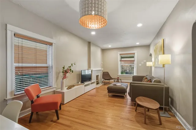 a living room with furniture and a lamp