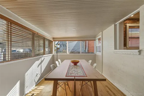 a balcony with wooden floor and furniture